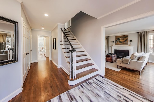 stairway with crown molding and hardwood / wood-style flooring