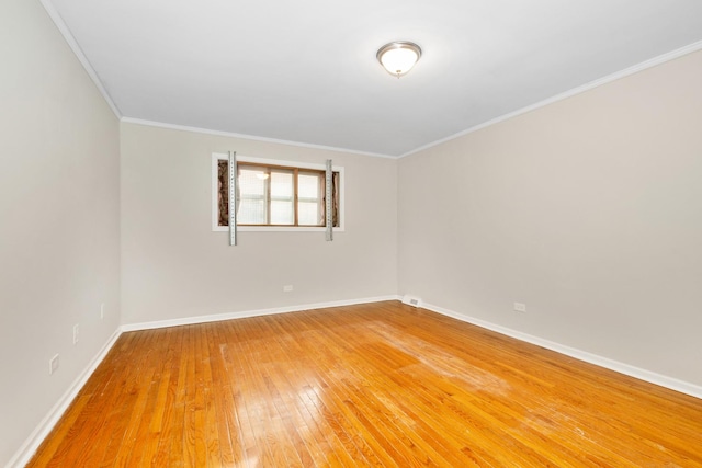 unfurnished room featuring ornamental molding and hardwood / wood-style floors