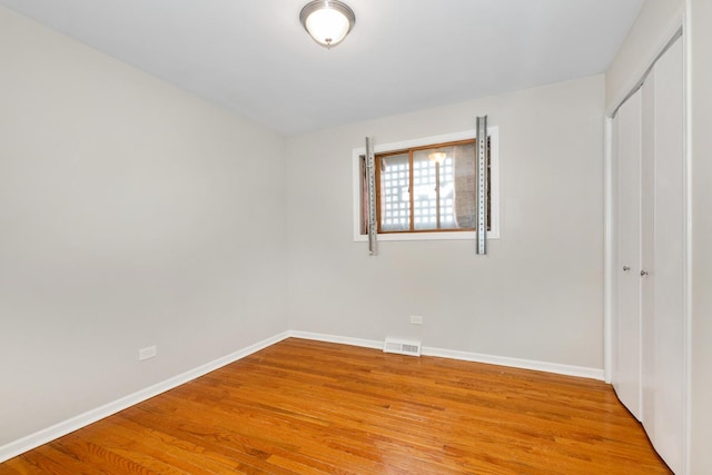 unfurnished bedroom featuring a closet and wood-type flooring