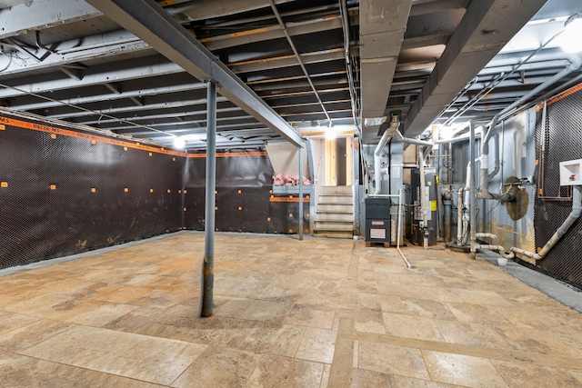 basement featuring heating unit and water heater