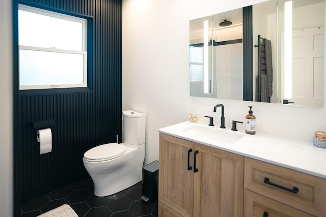 bathroom featuring toilet, vanity, and tile patterned floors