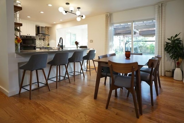 dining area with light hardwood / wood-style floors and sink