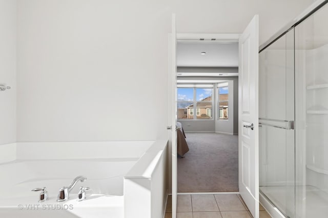 bathroom featuring separate shower and tub and tile patterned floors