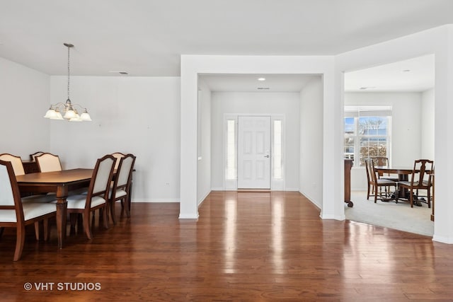 foyer featuring dark hardwood / wood-style flooring and a notable chandelier