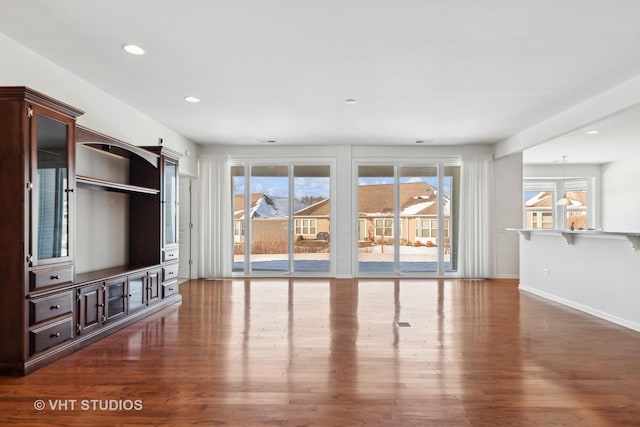 unfurnished living room featuring dark hardwood / wood-style flooring