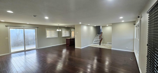 unfurnished living room featuring dark wood-type flooring