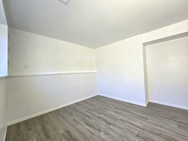 empty room with dark wood-type flooring