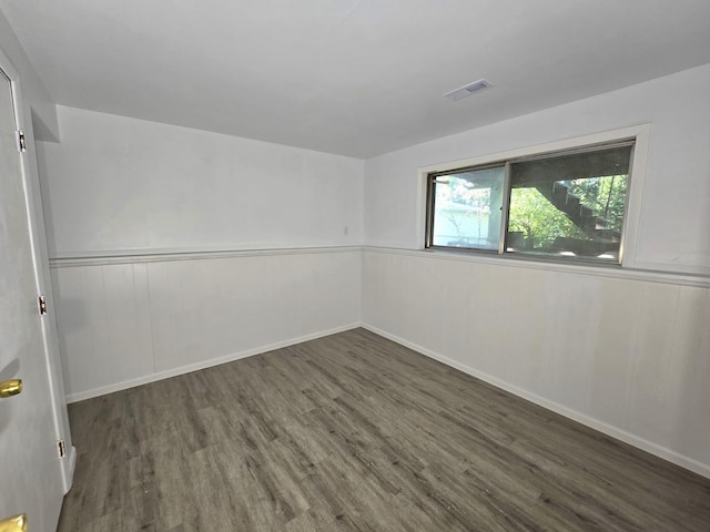 unfurnished room with dark hardwood / wood-style floors