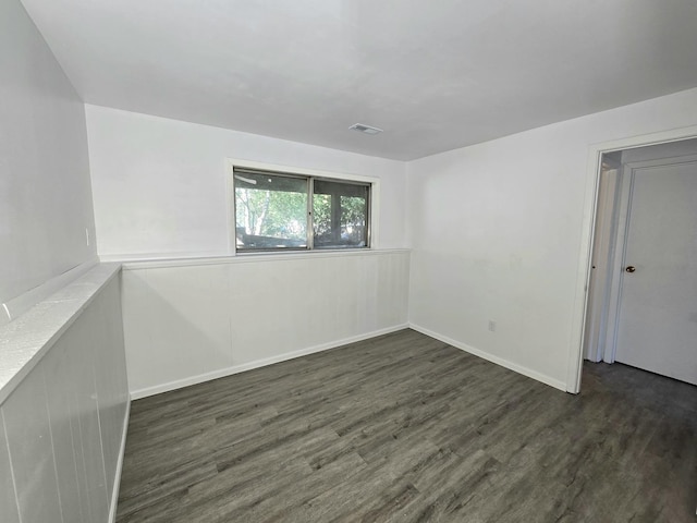 spare room featuring dark hardwood / wood-style floors