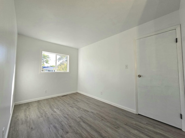 unfurnished room with hardwood / wood-style floors