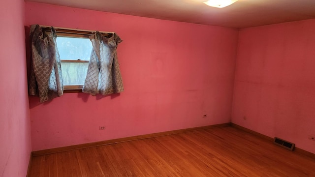 unfurnished room featuring hardwood / wood-style floors