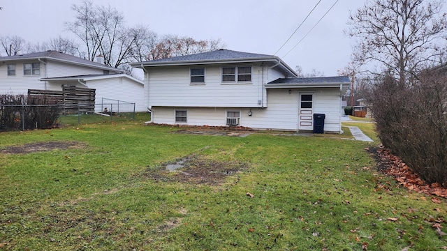 rear view of house featuring a lawn