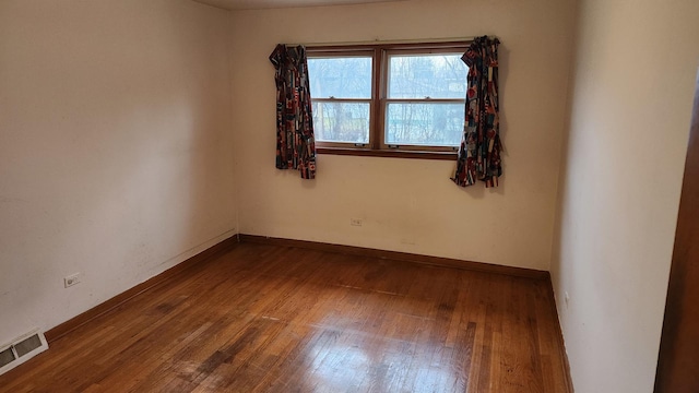 spare room with hardwood / wood-style floors