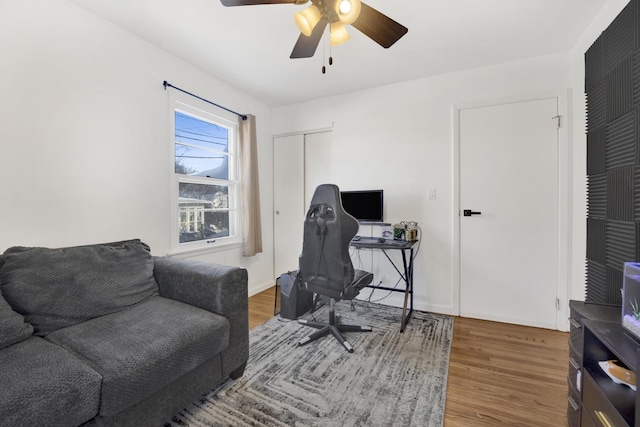 home office with ceiling fan and hardwood / wood-style floors