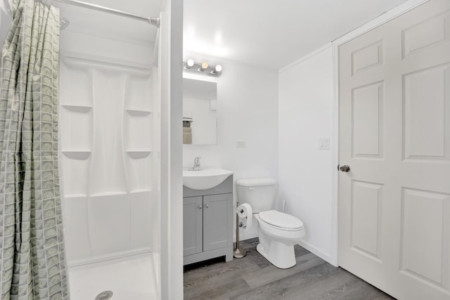 bathroom featuring walk in shower, toilet, vanity, and wood-type flooring