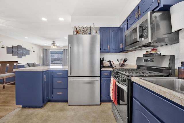 kitchen featuring appliances with stainless steel finishes, ceiling fan, and blue cabinetry