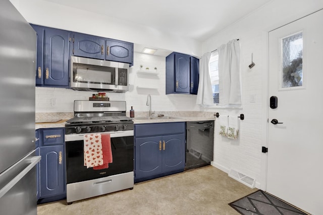 kitchen featuring sink, blue cabinetry, tasteful backsplash, and appliances with stainless steel finishes