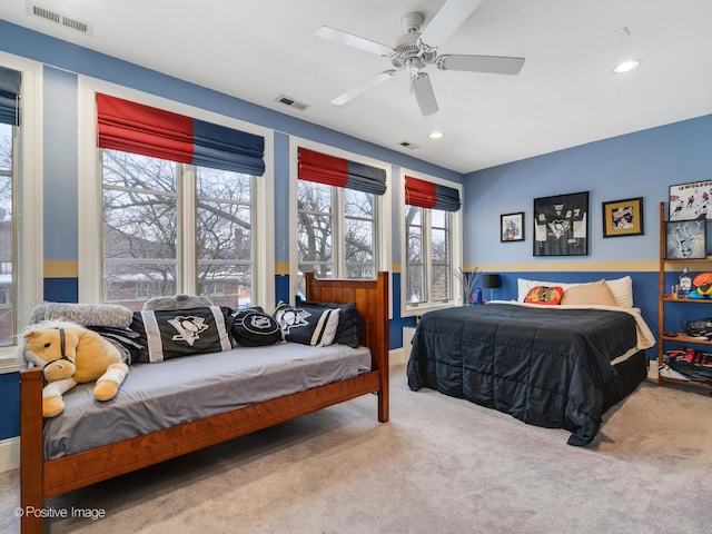 bedroom with light carpet and ceiling fan