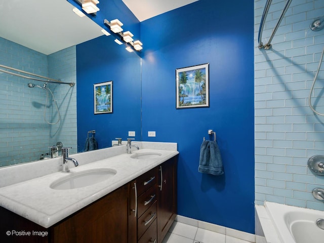 bathroom with vanity, tile patterned floors, and tiled shower / bath