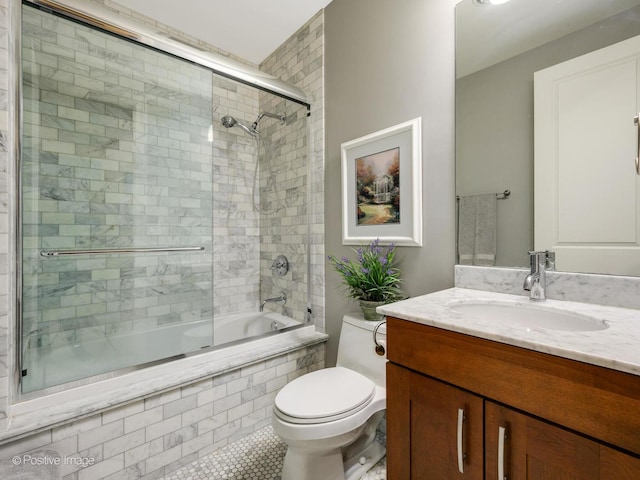 full bathroom with toilet, bath / shower combo with glass door, and vanity