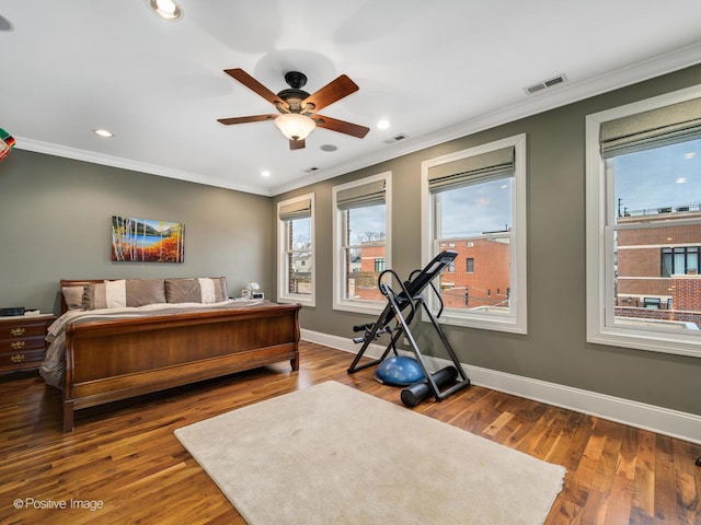 bedroom with ceiling fan, hardwood / wood-style floors, and ornamental molding