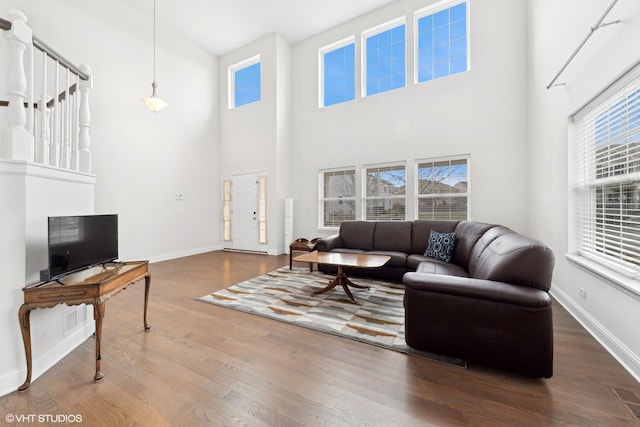 living room featuring hardwood / wood-style flooring and a high ceiling