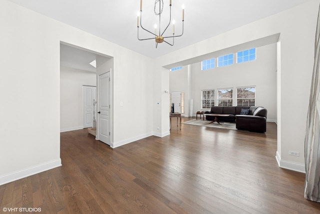 interior space with dark wood-type flooring and a chandelier