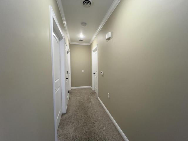 hallway featuring crown molding and light colored carpet