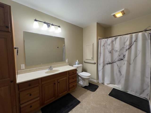 bathroom with toilet, walk in shower, and vanity