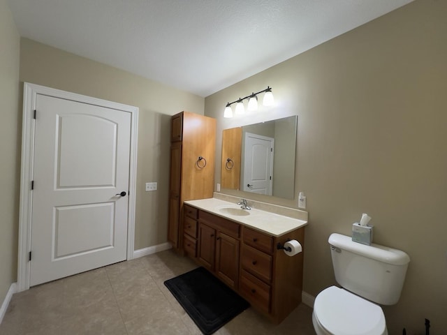 bathroom with tile patterned flooring, vanity, and toilet