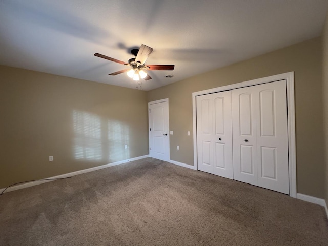 unfurnished bedroom featuring carpet floors, ceiling fan, and a closet