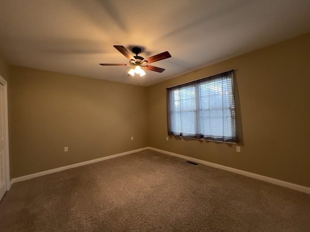 empty room featuring ceiling fan and carpet floors