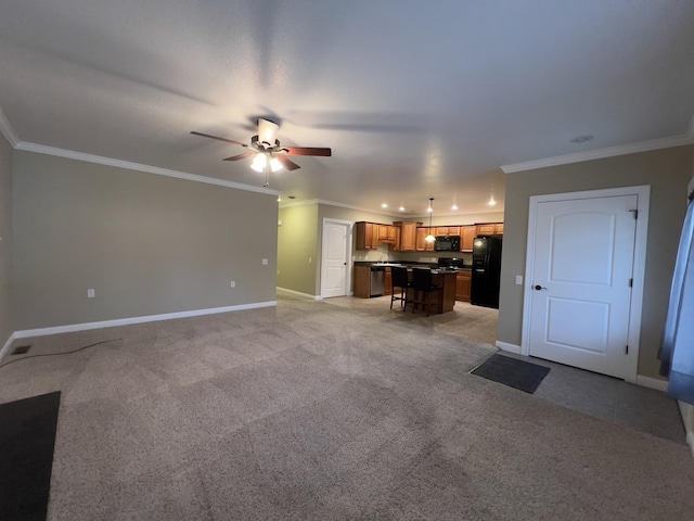 carpeted living room with ornamental molding and ceiling fan