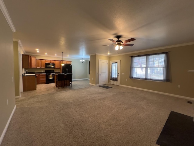 unfurnished living room with ornamental molding and light carpet