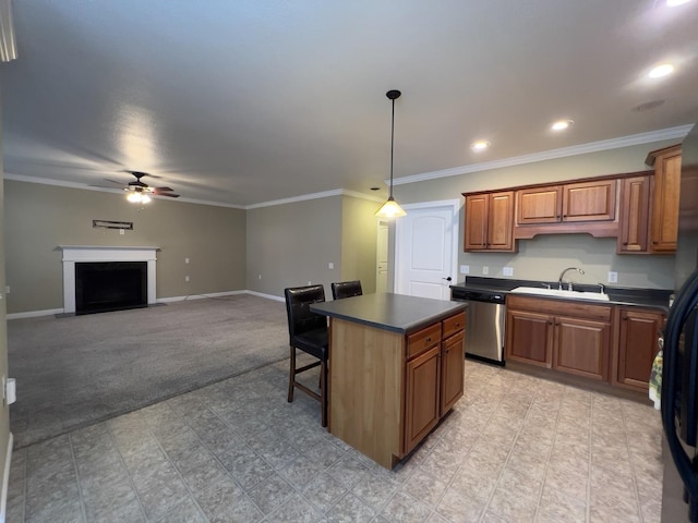 kitchen with sink, dishwasher, ceiling fan, a breakfast bar area, and a kitchen island