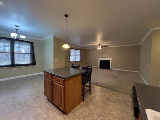 kitchen with decorative light fixtures, ornamental molding, a healthy amount of sunlight, and a center island