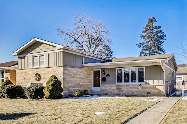 tri-level home with a front lawn