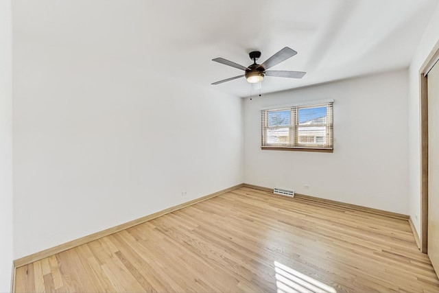 empty room featuring ceiling fan and light hardwood / wood-style flooring