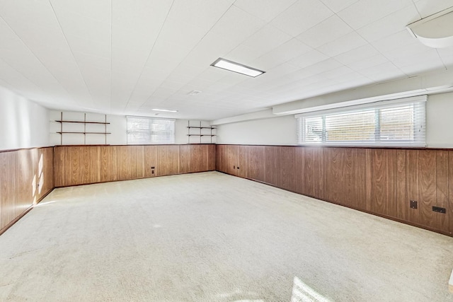 basement with wooden walls and light carpet