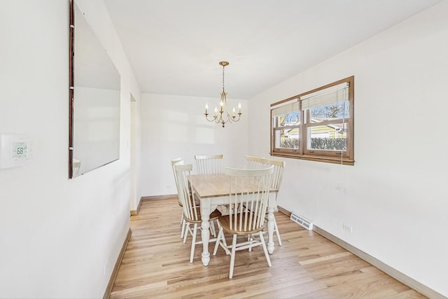 unfurnished dining area featuring a chandelier and light hardwood / wood-style flooring