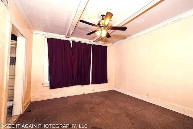 spare room featuring ceiling fan, ornamental molding, dark carpet, and baseboards