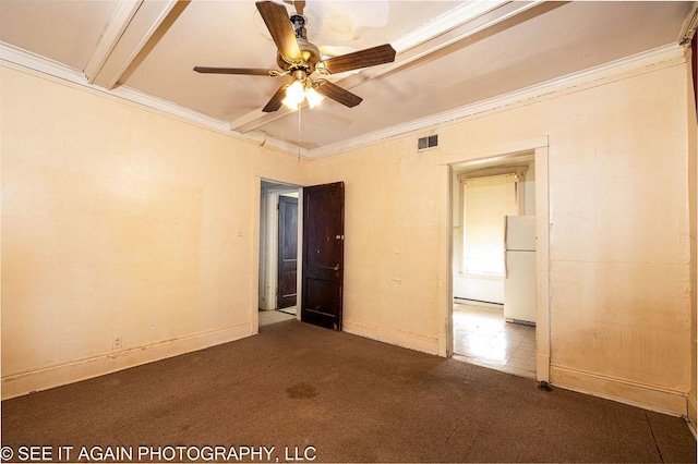 empty room with baseboards, visible vents, a ceiling fan, ornamental molding, and carpet flooring