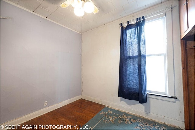 unfurnished room with a ceiling fan, baseboards, and wood finished floors