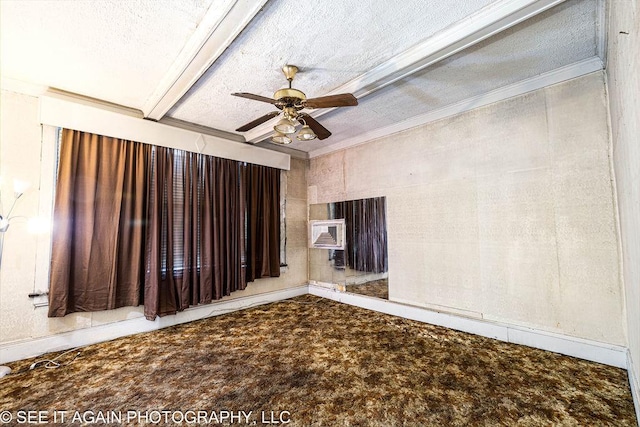 empty room featuring ornamental molding, beamed ceiling, a textured ceiling, and a ceiling fan