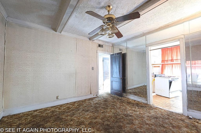 carpeted empty room with a textured ceiling, a ceiling fan, beamed ceiling, and ornamental molding