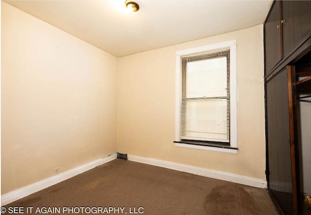 spare room featuring baseboards