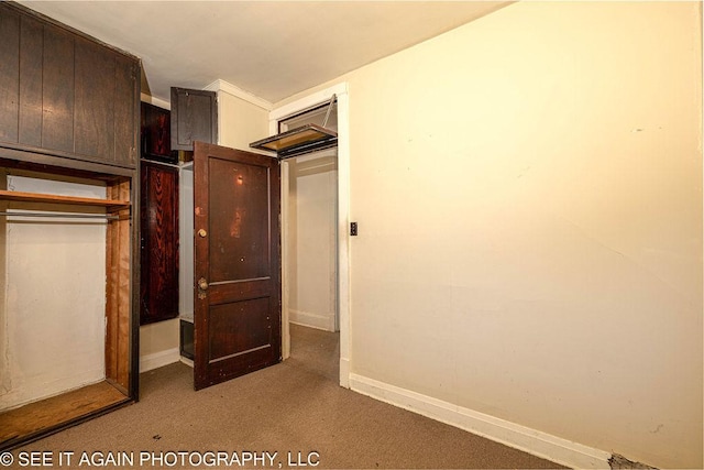 unfurnished bedroom featuring a closet, carpet, and baseboards