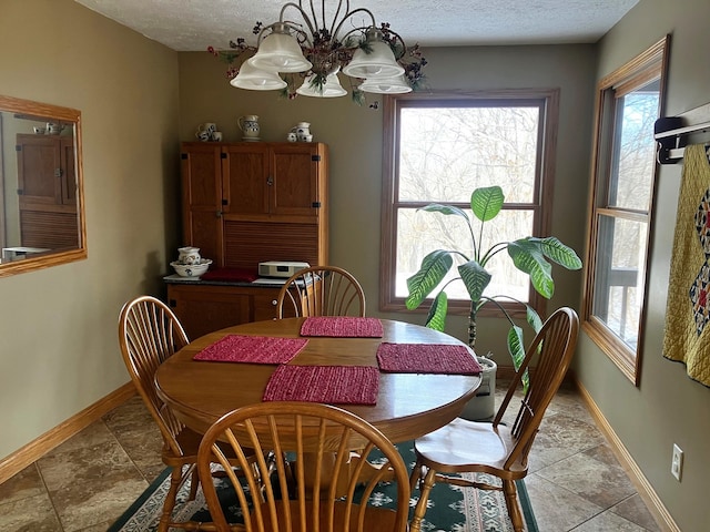 dining area featuring a textured ceiling and an inviting chandelier