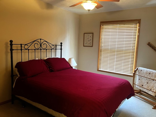 carpeted bedroom with a textured ceiling and ceiling fan