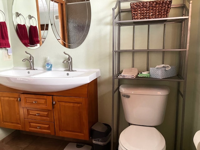 bathroom featuring toilet, tile patterned flooring, and vanity